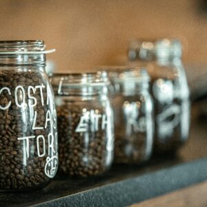 Close-up of labeled glass jars filled with coffee beans on a countertop in Bursa, Türkiye.